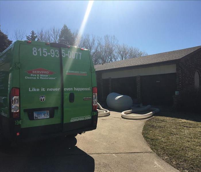 SERVPRO truck outside of home with equipment visible