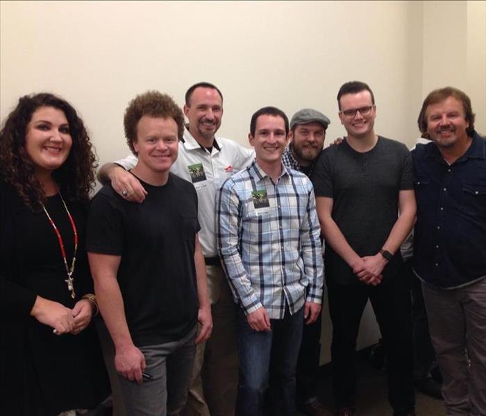 SERVPRO representative with the members of the band Casting Crowns