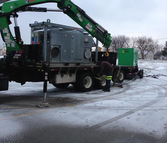 Large drying equipment in snowy parking lot