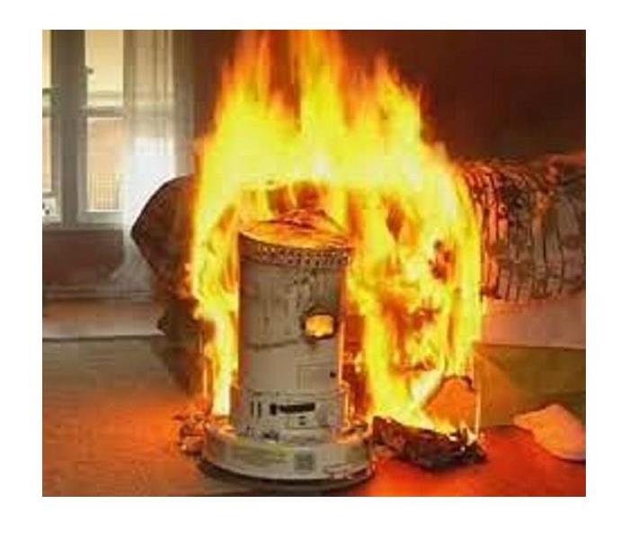 Space heater on fire in bedroom next to bed